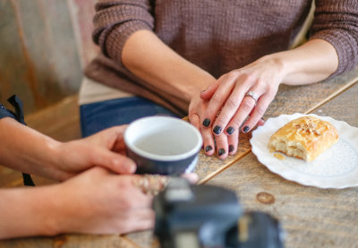 A photo of people sitting at a table drinking artisan coffee